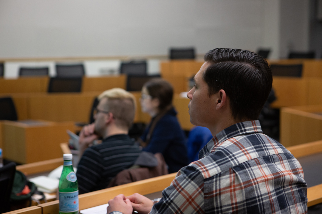 A student listening to an applied economics lecture