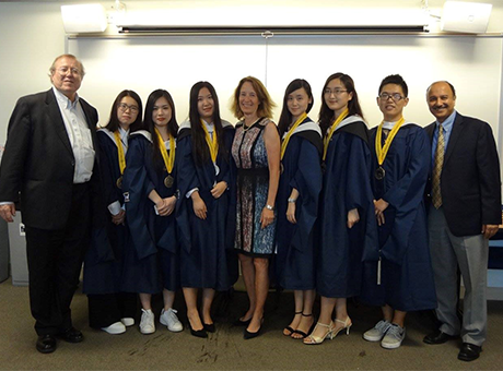 The first graduates of the MA Program in Applied Economics with Professors Joe Cordes (far left), Joann Wiener (program director, center) and Sumit Joshi (far right)