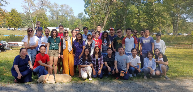 Current econ grad students joined by alumni, friends, family—and an adorable dog. 
