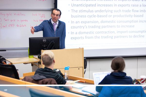 Professor Daniel Marcin lectures a class. Watch the video about the Department of Economics to find out more.