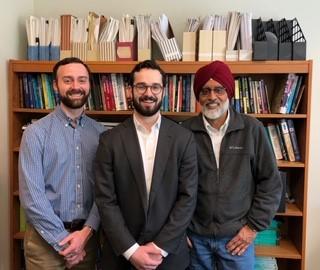Joseph Hancuch (center) with Professors Bryan Stuart (left) and Arun Malik (right).