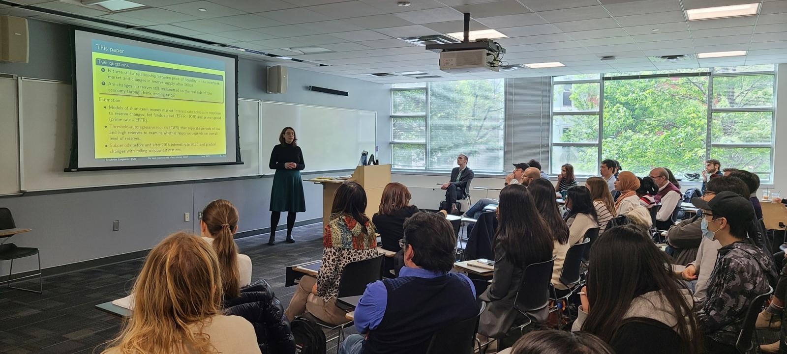 person presenting to a room of students