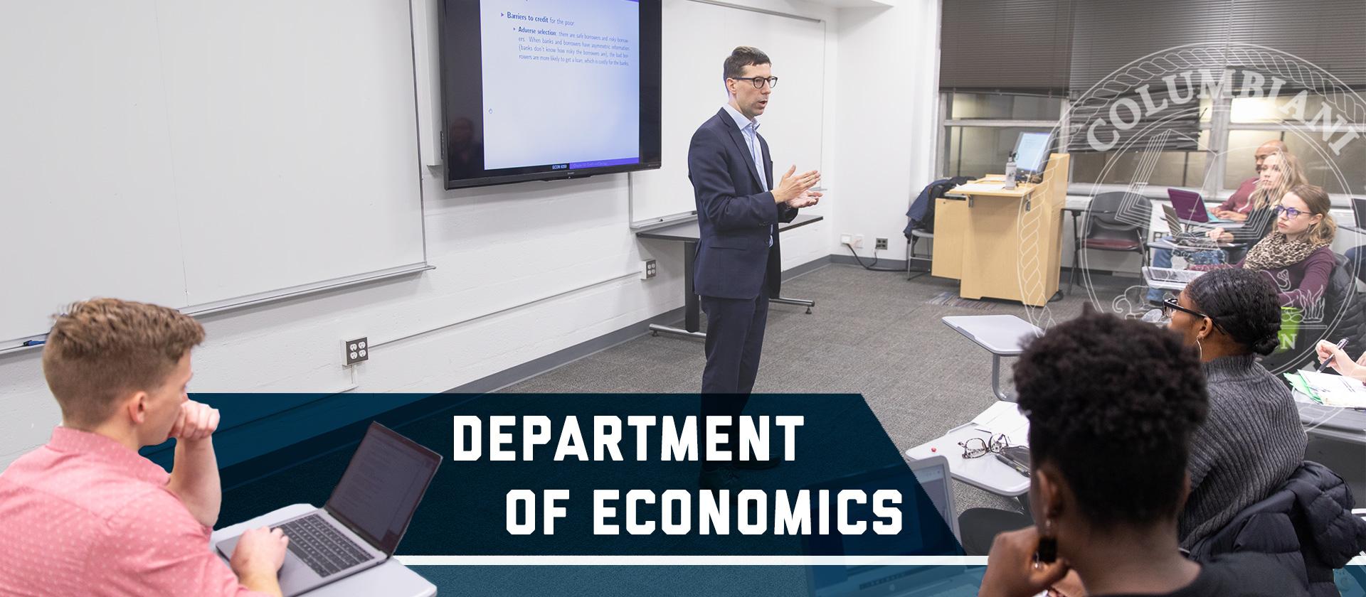 Department of Economics with Columbian College seal. Professor Remi Jedwab teaches a class in front of a whiteboard